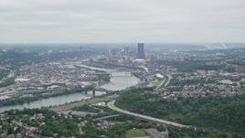 4.8K aerial stock footage tilting up from homes to reveal skyscrapers, Downtown Pittsburgh, Pennsylvania Aerial Stock Footage | AX105_075E