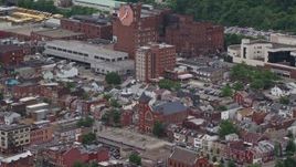 4.8K aerial stock footage of urban apartment buildings near a factory, Pittsburgh, Pennsylvania Aerial Stock Footage | AX105_168E