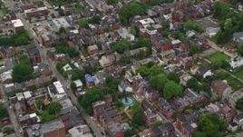 4.8K aerial stock footage flying over town houses and row houses and reveal school, Pittsburgh, Pennsylvania Aerial Stock Footage | AX105_206E