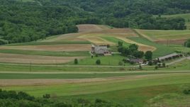 4.8K aerial stock footage of a farmhouse and farmland in Beaver Falls, Pennsylvania Aerial Stock Footage | AX106_044E