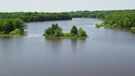 4.8K aerial stock footage of a tiny Island with trees in Akron City Reservoir, Chagrin Falls Aerial Stock Footage | AX106_157E