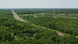 4.8K aerial stock footage orbiting a highway by forest in Chagrin Falls, Ohio Aerial Stock Footage | AX106_166