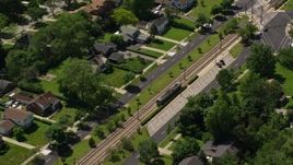 4.8K aerial stock footage of a commuter train and suburban homes in Cleveland, Ohio Aerial Stock Footage | AX106_191