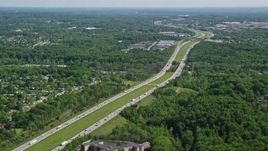4.8K aerial stock footage of Interstate with light traffic bordered by trees, Cleveland, Ohio Aerial Stock Footage | AX107_060E