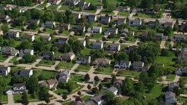 4.8K aerial stock footage of suburban homes among trees; Solon, Ohio Aerial Stock Footage | AX107_065E