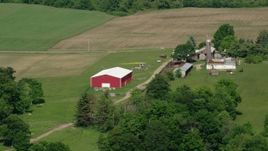 4.8K aerial stock footage flying by a farm with a red barn, Aurora, Ohio Aerial Stock Footage | AX107_079