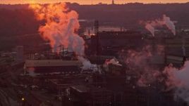 4K aerial stock footage of U.S. Steel Mon Valley Works and smoke stacks, Braddock, Pennsylvania, sunset Aerial Stock Footage | AX108_019E