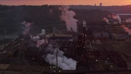 4K aerial stock footage passing buildings at the U.S. Steel Mon Valley Works, Braddock, Pennsylvania, sunset Aerial Stock Footage | AX108_024E