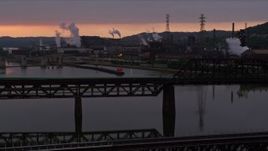 4K aerial stock footage of U.S. Steel Mon Valley Works viewed from a bridge, Braddock, Pennsylvania, sunset Aerial Stock Footage | AX108_031E