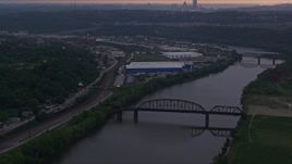 4K aerial stock footage flying over bridges on the Monogahela River, Munhall, Pennsylvania, twilight Aerial Stock Footage | AX108_041E