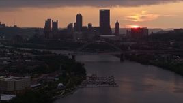 4K aerial stock footage of Downtown Pittsburgh skyline seen from the Monongahela River, Pennsylvania, sunset Aerial Stock Footage | AX108_052E
