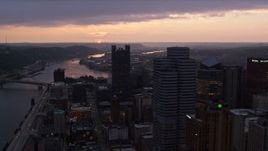 4K aerial stock footage of Fort Pitt Bridge spanning Ohio River, Downtown Pittsburgh, Pennsylvania, twilight Aerial Stock Footage | AX108_079