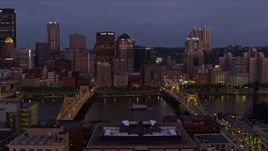 4K aerial stock footage flying by bridges and Downtown Pittsburgh skyscrapers, Pennsylvania, twilight Aerial Stock Footage | AX108_118E