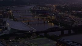 4K aerial stock footage of bridges spanning the Allegheny River near PNC Park, Downtown Pittsburgh, twilight Aerial Stock Footage | AX108_134E