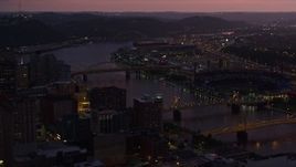 4K aerial stock footage of PNC Park, Heinz Field and bridges spanning Allegheny River, Pittsburgh, Pennsylvania, twilight Aerial Stock Footage | AX108_141E