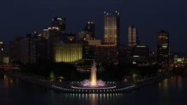 4K aerial stock footage flying by Downtown Pittsburgh and Point State Park, Pennsylvania, night Aerial Stock Footage | AX108_168E