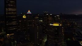 4K aerial stock footage flying by Gulf Tower and U.S. Steel Tower, Pittsburgh, Pennsylvania, night Aerial Stock Footage | AX108_174E