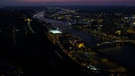 4K aerial stock footage of bridges spanning the Monongahela River, Downtown Pittsburgh, Pennsylvania, night Aerial Stock Footage | AX108_194E