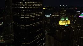 4K aerial stock footage passing by city buildings, Gulf Tower and U.S. Steel Tower, Pittsburgh, night Aerial Stock Footage | AX108_224E