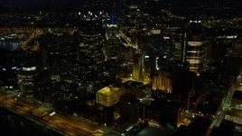 4K aerial stock footage flying by office buildings while approaching PPG Place, Downtown Pittsburgh, night Aerial Stock Footage | AX108_228E