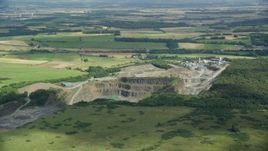5.5K aerial stock footage orbit quarry surrounded by farmland, Denny, Scotland Aerial Stock Footage | AX109_008E