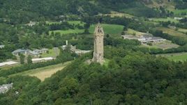 5.5K aerial stock footage of orbiting iconic Wallace Monument looking down on residential area, Stirling, Scotland Aerial Stock Footage | AX109_048E
