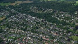 5.5K aerial stock footage of a residential neighborhood and trees, Stirling, Scotland Aerial Stock Footage | AX109_056E
