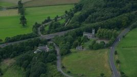 5.5K aerial stock footage of M9 Highway lined with trees, Stirling, Scotland Aerial Stock Footage | AX109_058E