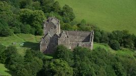 5.5K aerial stock footage of orbiting Doune Castle with tourists on the grounds, Scotland Aerial Stock Footage | AX109_070E