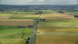 5.5K aerial stock footage fly over roundabout on A905 highway by farm fields, Falkirk, Scotland Aerial Stock Footage | AX109_114E