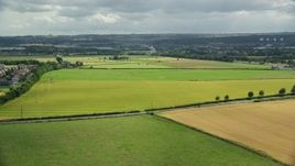5.5K aerial stock footage fly over Scottish farm fields toward The Kelpies sculptures, Falkirk, Scotland Aerial Stock Footage | AX109_118E