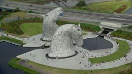5.5K aerial stock footage of circling The Kelpies sculptures in Falkirk, Scotland Aerial Stock Footage | AX109_128E