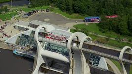5.5K aerial stock footage of orbiting two ferries on iconic Falkirk Wheel boat lift, Scotland Aerial Stock Footage | AX109_145E