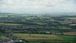 5.5K aerial stock footage of farmland and a Scottish village, Bonnybridge, Scotland Aerial Stock Footage | AX109_165E
