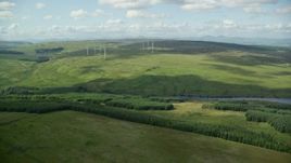 5.5K aerial stock footage of an approach to windmills and a green countryside, Denny, Scotland Aerial Stock Footage | AX110_011E