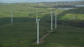 5.5K aerial stock footage of windmills on green countryside, Denny, Scotland Aerial Stock Footage | AX110_013E
