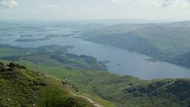 5.5K aerial stock footage of Loch Lomond seen from Ben Lomond, Scottish Highlands, Scotland Aerial Stock Footage | AX110_051