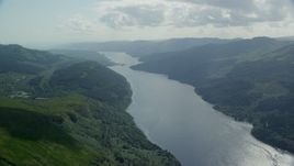 5.5K aerial stock footage of Loch Long flowing past lush green mountains, Scottish Highlands, Scotland Aerial Stock Footage | AX110_068E