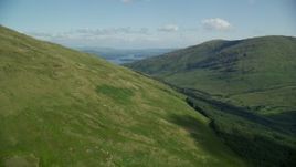 5.5K aerial stock footage approach blue waters of Loch Lomond from green peaks, Scottish Highlands, Scotland Aerial Stock Footage | AX110_097E