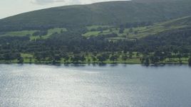 5.5K aerial stock footage of a waterfront golf course on Loch Lomond in Luss, Scottish Highlands, Scotland Aerial Stock Footage | AX110_112