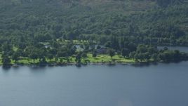 5.5K aerial stock footage of an approach to Rossdhu Mansion at Loch Lomond Golf Course, Luss, Scottish Highlands, Scotland Aerial Stock Footage | AX110_113E