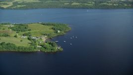 5.5K aerial stock footage of orbiting sailboats along a Loch Lomond island, Scottish Highlands, Scotland Aerial Stock Footage | AX110_124