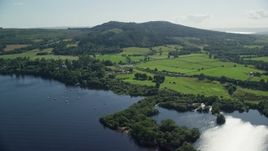 5.5K aerial stock footage of farms beside Loch Lomond, Arden, Scottish Highlands, Scotland Aerial Stock Footage | AX110_125