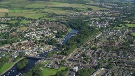 5.5K aerial stock footage fly over small bridges on River Leven in a small town, Alexandria, Scotland Aerial Stock Footage | AX110_131E