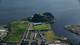 5.5K aerial stock footage of Dumbarton Castle and soccer stadium beside the water, Scotland Aerial Stock Footage | AX110_140E