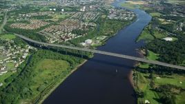 5.5K aerial stock footage of a bird's eye orbit of Erskine Bridge by residential neighborhoods, Glasgow, Scotland Aerial Stock Footage | AX110_144E