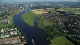 5.5K aerial stock footage fly over River Clyde toward farm fields and residential communities, Glasgow, Scotland Aerial Stock Footage | AX110_146