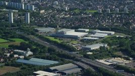 5.5K aerial stock footage of M8 Freeway near warehouse buildings, Glasgow, Scotland Aerial Stock Footage | AX110_152