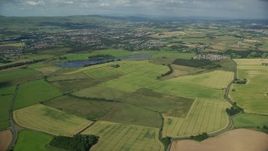 5.5K aerial stock footage approach farming fields and rural neighborhoods outside of Glasgow, Scotland Aerial Stock Footage | AX110_219E