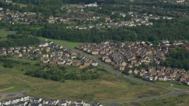 5.5K aerial stock footage of suburban homes and trees, Cumbernauld, Scotland Aerial Stock Footage | AX110_228